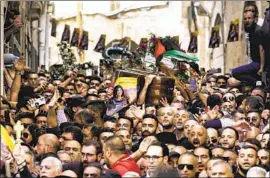  ?? Mahmoud Illean Associated Press ?? MOURNERS carry the casket of Shireen abu Akleh, a Palestinia­n American reporter for Al Jazeera, shot dead during an Israeli military raid in the West Bank.