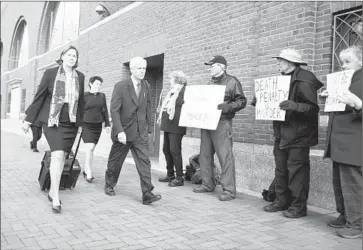  ?? Scott Eisen Getty Images ?? DEFENSE TEAM members Judy Clarke, left, Miriam Conrad and David Bruck pass people protesting capital punishment before closing arguments in the trial of Boston Marathon bomber Dzhokhar Tsarnaev.