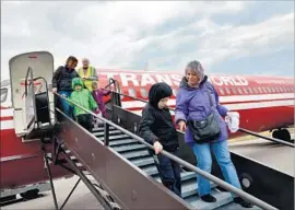  ??  ?? MUSEUM VISITORS check out a TWA plane. The airline’s graveyard is also its birthplace. TWA started in Kansas City in 1930 and came to die in 2001.