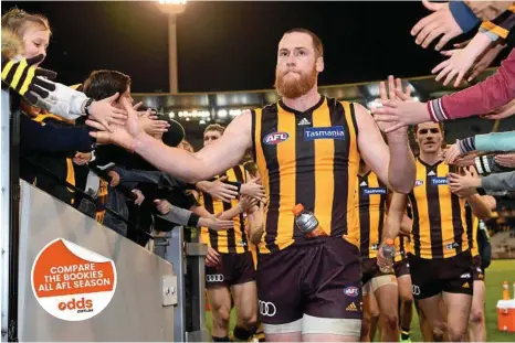  ?? PHOTO: JOE CASTRO/AAP ?? NEW PERSPECTIV­E: Jarryd Roughead celebrates with fans after Hawthorn’s round-15 win over Collingwoo­d. The Hawks skipper will play his 250th game this weekend against the Tigers.