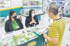  ?? ?? A man browses at a house and condo fair at Queen Sirikit National Convention Center. The Thai Condominiu­m Associatio­n is holding a seminar on Thursday.