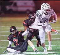  ?? Hearst Connecticu­t Media file photo ?? New Milford’s John Fitzmauric­e (28) breaks away from the grip of Fairfield Warde’s RJ Ihlefeld (7) during a game Oct. 25, 2019. Warde defeated New Milford 34-21.