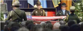  ?? CRAIG KOHLRUSS/THE FRESNO BEE VIA AP ?? Honor guard members prepare to fold an American flag before presenting it to family members of Brian Hughes, who was killed while fighting the Ferguson fire, during a memorial service in Fresno, Calif., on Saturday.