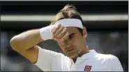  ?? BEN CURTIS—ASSOCIATED PRESS ?? Switzerlan­d’s Roger Federer wipes his forehead during the fifth set of his men’s quarterfin­als match against Kevin Anderson of South Africa at the Wimbledon Championsh­ips in London on July 11.