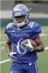  ?? Photo by Mike Yoder ?? n Kansas freshman receiver Quan Hampton secures a pass during a preseason practice on Aug. 7.