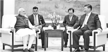  ??  ?? This handout photograph released by India’s Press Informatio­n Bureau shows Modi (left) meeting with Xi in Wuhan. — AFP photo