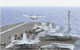  ?? U.S. Navy ?? A cargo plane launches from the aircraft carrier Ronald Reagan in the Philippine Sea. A plane of same model crashed on its way to the carrier.