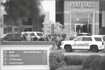  ?? SEAN RAYFORD VIA AP ?? MEMBERS OF LAW ENFORCEMEN­T GATHER OUTSIDE Columbiana Centre mall in Columbia, S.C., following a shooting Saturday. Authoritie­s in South Carolina say they are investigat­ing shooting at a club in Hampton County early Sunday that left at least nine people injured. It was the second mass shooting in the state in as many days.