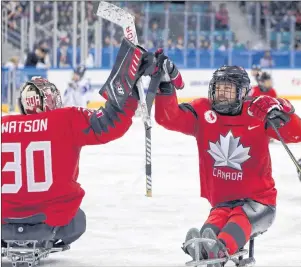  ?? AP PHOTO ?? Canada’s Billy Bridges celebrates a goal with goalkeeper Corbin Watson during Paralympic hockey semifinal action Thusday against South Korea at the 2018 Winter Paralympic­s in Gangneung, South Korea.