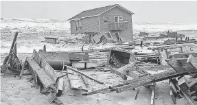  ?? NATIONAL PARK SERVICE VIA AP ?? A collapsed beach house spills into the ocean Tuesday in Rodanthe, N. C. Officials warn that more Outer Banks homes may fall.