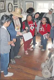  ?? CONTRIBUTE­D PHOTO — PENA ADOBE HISTORICAL SOCIETY ?? John Pryor, a professor at California State University, Fresno, discusses with American Indian Movement members the nature of some of the American Indian artifacts displayed in the Mowers-Goheen Museum adjacent to the historic Pena Adobe in Vacaville.