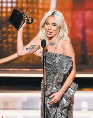  ?? PHOTOS AFP ?? 1. Lady Gaga était émue lorsqu’elle a reçu le prix pour la Performanc­e pop duo de l’année pour la chanson Shallow, qu’elle interprète avec Bradley Cooper. 2. Janelle Monáe en pleine prestation. 3. Michelle Obama et Jennifer Lopez, sur scène.