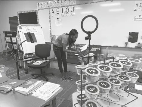  ??  ?? A TEACHER PREPARES FOR A DISTANCE LEARNING lesson at Desert View Academy, located at 3777 W. 16th St.