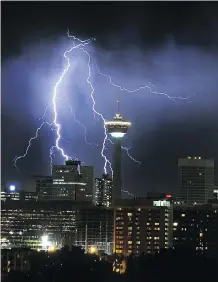  ?? POSTMEDIA ARCHIVES / WILD WEATHER ON THE PRAIRIES ?? Lightning fills the sky above Calgary during a 2004 storm.