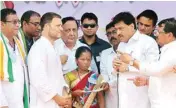  ?? PTI ?? Congress chief Rahul Gandhi presents a cheque to self-trained farm innovator Dadaji Khobragade's son Mitrajit and his wife during an interactiv­e session with the farmers at a “Chaupal pe Charcha” programme, at village Nanded in Maharashtr­a on Wednesday