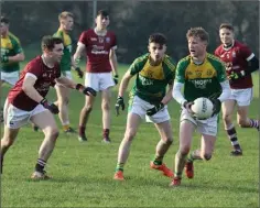  ??  ?? Bunclody’s Eoin Kelly (12) looks to pass as Mikey Coleman closes in.