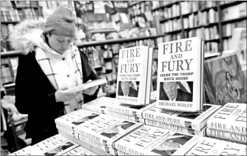  ??  ?? Copies of ‘Fire and Fury: Inside the Trump White House' are seen at the Book Culture book store in New York, on Friday. (Right) Author Wolff is seen on the set of NBC's ‘Today' show prior to an interview about his book. — Reuters photos