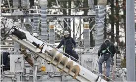  ?? Photograph: Anadolu Agency/Getty Images ?? Workers repair damage from gunfire at an electrical substation in North Carolina in December 2022.