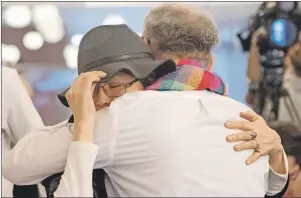  ?? CP PHOTO ?? Beaverhous­e First Nation Chief Marcia Brown Martel (left) hugs the plaintiffs co-lawyer Jeffrey Wilson during a news conference in Toronto on Tuesday.