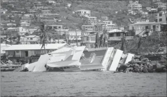  ?? ERIKA P. RODRIGUEZ, NYT ?? A boat wrecked by hurricane Irma in Cruz Bay on St. John in the U.S. Virgin Islands. On St. John, supply helicopter­s buzzed over the once-powdery beaches where vacationer­s had soaked up the sun.