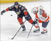  ?? Reed Saxon Associated Press ?? PHILADELPH­IA right winger Jakub Voracek, right, battles his counterpar­t on the Ducks, Corey Perry, in the first period of their game at the Honda Center.