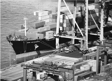  ??  ?? A container ship sit berthed next to gantry cranes at the Kwai Tsing Container Terminals in Hong Kong, China, on Nov 24, 2014.