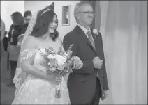  ??  ?? Alyssa Griffin is escorted into the wedding ceremony by her stepfather, John
Yerger.