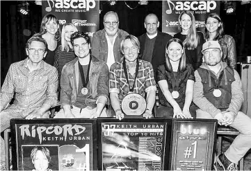  ??  ?? Keith Urban, centre, celebrates his No. 1 song “Blue Ain’t Your Color” with the writers and publishers. Steven Lee Olsen is left of Urban; to the right are writers Hillary Lindsey and Clint Lagerberg. — Courtesy of Steven Lee Olsen