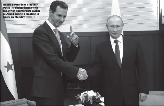  ??  ?? Russia’s President Vladimir Putin (R) shakes hands with his Syrian counterpar­t Bashar al-Assad during a meeting in Sochi on Monday.