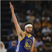  ?? NHAT V. MEYER — BAY AREA NEWS GROUP ?? The Warriors' Klay Thompson (11) celebrates his 3-point basket against the Memphis Grizzlies in the fourth quarter of Game 1 of a second-round playoff series at the FedEx Forum in Memphis, Tenn., on Sunday.