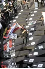  ??  ?? (Left) At Friday’s protest march to commemorat­e the 3rd anniversar­y of the Maguindana­o Ampatuan Massacre, the Impunity Monster holds a weapon and has the head of a backhoe. (Above) Mock coffins of the journalist victims. ( Top) Principal accused...