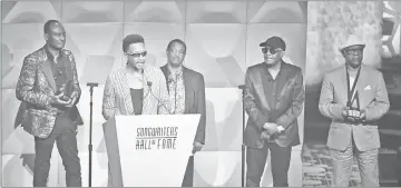  ??  ?? James ‘JT’ Taylor (second from left) gives a speech on stage as George Brown (left to right), Robert ‘Kool’ Bell, Ronald Bell and Dennis Thomas of Kool &amp; The Gang listen during the Songwriter­s Hall of Fame 49th Annual Induction and Awards Dinner on Thursday.