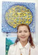  ??  ?? Mary Ann B. Reyes with her artwork