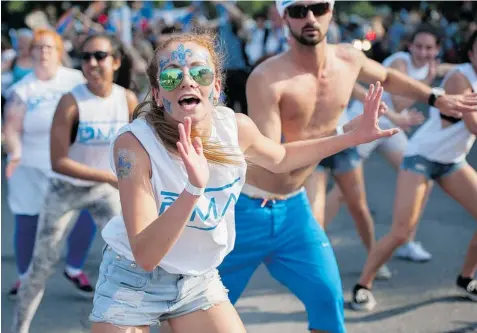  ?? JUSTIN TANG/ THE GAZETTE ?? Dancers perform at the annual St-Jean-Baptiste parade on Monday. The parade also featured theatre troupes and, naturally, politician­s.