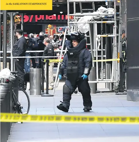  ?? TIMOTHY A. CLARY / AFP / GETTY IMAGES ?? A bomb squad officer exits the Time Warner Building in New York Wednesday, where a “live explosive device” was found in CNN’S New York bureau, prompting an on-air evacuation of the building. The device was linked to bombs sent to the Clintons, Obamas and liberal donor George Soros.