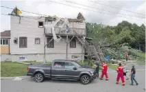  ?? THE CANADIAN PRESS ?? About 150 homes in Lachute were damaged — including this one, which lost its roof — when a tornado struck the town.