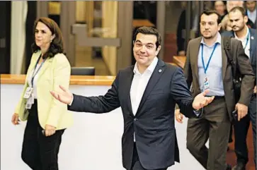  ?? MICHEL EULER/AP ?? Greek Prime Minister Alexis Tsipras, center, leaves after an emergency meeting Tuesday in Brussels with eurozone leaders, who expressed frustratio­n with proposals by Greece they considered inadequate to resolve its debt crisis.