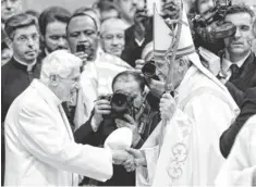  ?? FABIO FRUSTACI, EUROPEAN PRESSPHOTO AGENCY ?? Pope Emeritus Benedict XVI, left, and Pope Francis greet each other in St. Peter's Basilica at the Vatican City on Saturday.