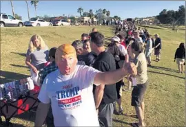  ?? Allen J. Schaben Los Angeles Times ?? JOE DeVINCENZO, sporting a Donald Trump mask, waits with other supporters for the GOP presidenti­al front-runner in Fountain Hills, Ariz., last month.