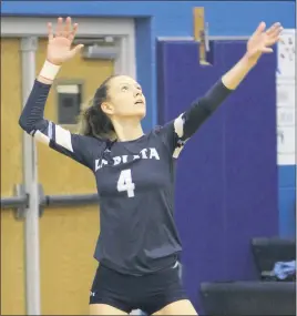  ?? STAFF PHOTO BY JOHN NISWANDER ?? La Plata junior Maddie Slattery serves the ball during Thursday night’s Southern Maryland Athletic Conference crossoverm­atch at Leonardtow­n. La Plata won in four sets to remain unbeaten on the season at 6-0.