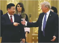  ?? ASSOCIATED PRESS FILE PHOTO ?? Chinese President Xi Jinping, left, and President Donald Trump arrive Nov. 9 for a state dinner in Beijing. First lady Melania Trump is seen behind Xi. Trump decided Thursday to impose punishing tariffs on tens of billions of dollars worth of Chinese...