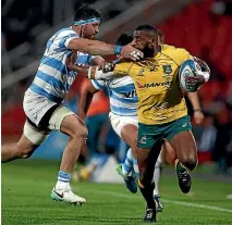  ??  ?? Marika Koroibete scores Australia’s first try in their 37-20 win over Argentina in Mendoza.