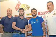  ??  ?? Sri Lankan interim head coach Nic Pothas (from left), Sri Lankan captain Upul Tharanga, Indian captain Virat Kohli and head coach Ravi Shastri pose after a press conference ahead of their series in Colombo. — PTI