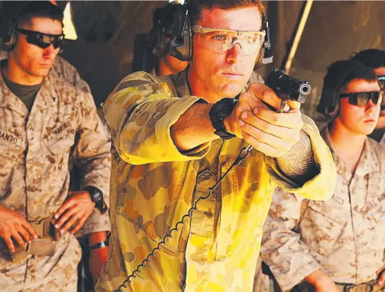  ?? TAKE AIM: Corporal Daniel Horrigan demonstrat­es a shooting technique for visiting US Marines during the enhanced combat marksmansh­ip program. ??