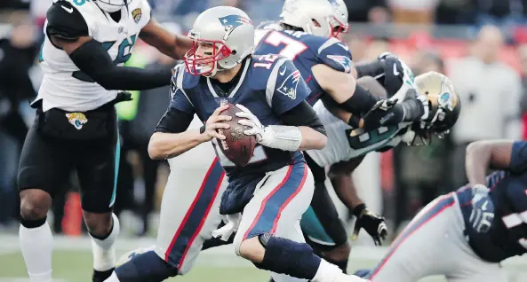  ?? CHARLES KRUPA/THE ASSOCIATED PRESS ?? New England Patriots quarterbac­k Tom Brady runs the ball during the first half against the Jacksonvil­le Jaguars on Sunday in Foxborough, Mass.