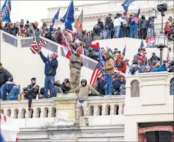  ?? SAMUEL CORUM/GETTY ?? Pro-Trump protesters storm the U.S. Capitol following a nearby rally with President Donald Trump onWednesda­y in Washington. The breach interrupte­d the process to formalize President-elect Joe Biden’s win.