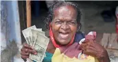  ?? PTI ?? A beneficiar­y shows the money that she received as Covid relief provided by the state government in Kanyakumar­i district on Tuesday.
—