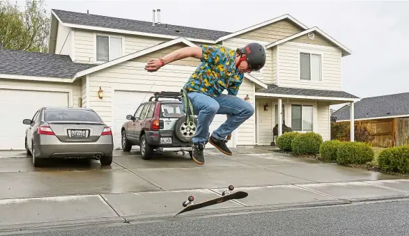  ?? — Photos: TNS ?? McClintock skateboard­ing outside his home. Nothing more extreme than a turn over move for him nowadays – and he always wears a helmet.