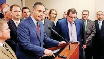  ?? [PHOTO BY JIM BECKEL, THE OKLAHOMAN] ?? Speaker Charles McCall, R-Atoka, explains to the media his reasoning for suspending special session activity in the House. Members of the Republican caucus stand behind him.