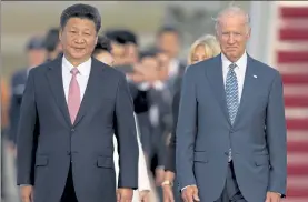  ?? CAROLYN KASTER / AP ?? Chinese President Xi Jinping and Vice President Joe Biden walk down the red carpet on the tarmac during an arrival ceremony in Andrews Air Force Base, Md., on Sept. 24, 2015.